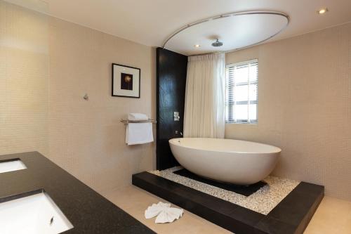 La salle de bains est pourvue d'une grande baignoire blanche. dans l'établissement The Residence Bangtao Villa 216, à Ban Thalat Choeng Thale