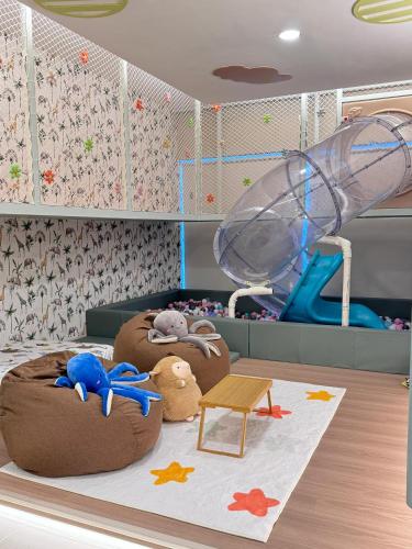 a childs room with two beds with toys on it at The Children's Playhouse, Medini, Iskandar Puteri, Johor in Iskandar Puteri