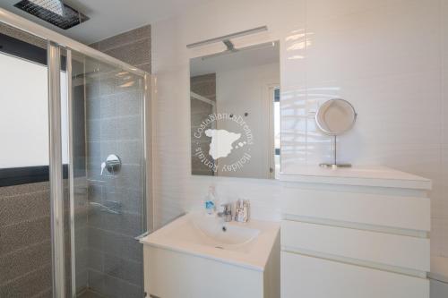 a white bathroom with a sink and a shower at CostaBlancaDreams Calpe Beach in Calpe in Alicante