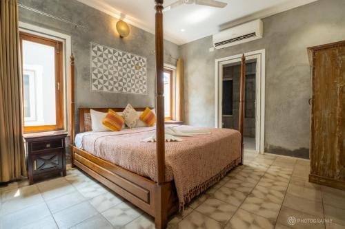 a bedroom with a bed and a window at Love Story Villas, Baga-Private Pool Villas in Arpora