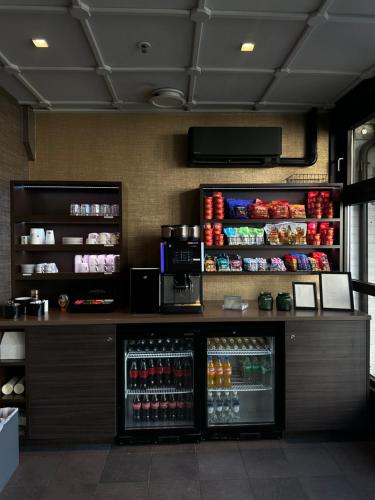 a drink counter in a restaurant with a refrigerator at Holmen Fjordhotell in Nesbru