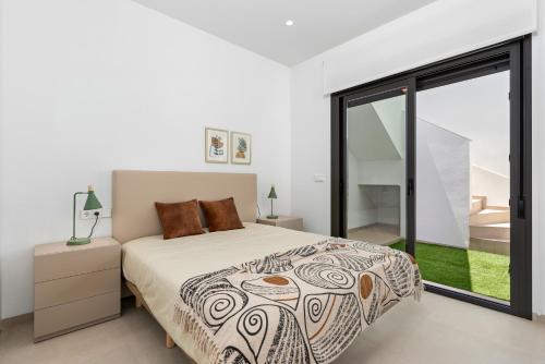 a bedroom with a bed and a large window at Villa Buba in Pilar de la Horadada