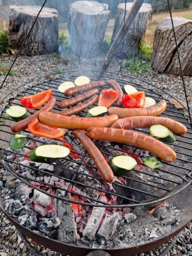 a bunch of hot dogs and vegetables on a grill at Rinken9 in Hinterzarten