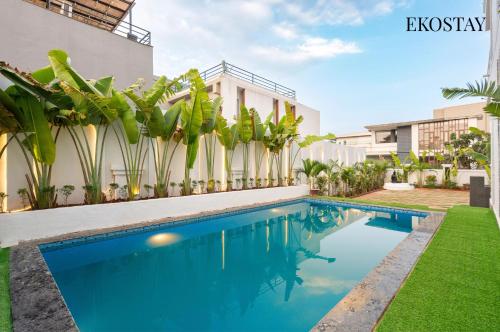 an image of a swimming pool in front of a building at EKOSTAY - Azure Villa in Lonavala