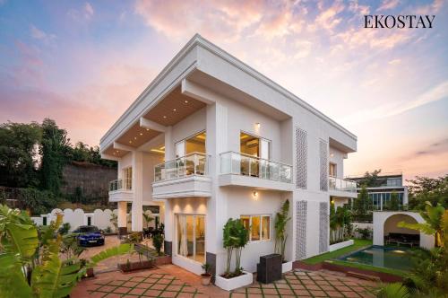 a villa with a view of the sunset at EKOSTAY - Azure Villa in Lonavala