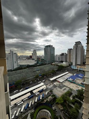 a city with buses parked in a parking lot at DH Suites in Manila