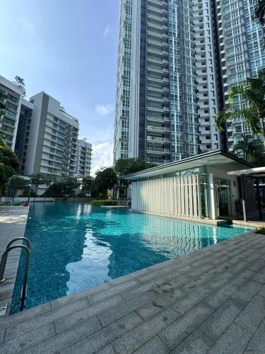 a swimming pool in a city with tall buildings at The Children's Playhouse, Medini, Iskandar Puteri, Johor in Iskandar Puteri