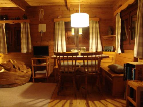 a room with a table and chairs in a cabin at Cabana de Santo António in Vila Nova de Cerveira