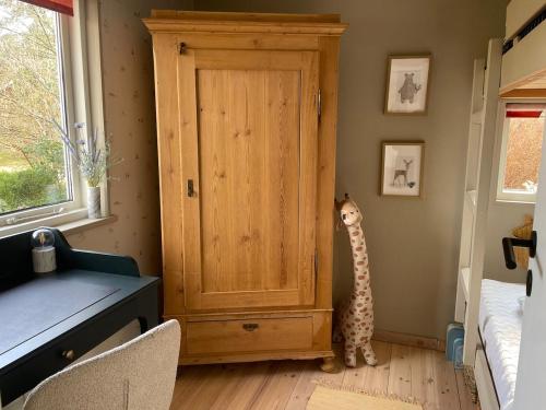 a cat standing next to a door in a room at Holiday home in beautiful nature in Vordingborg