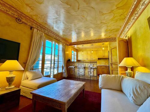 un salon avec un canapé et une table dans l'établissement Appartement Place des Lices, Saint-Tropez, à Saint-Tropez