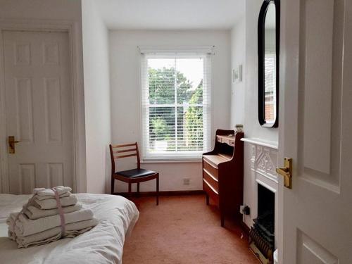 a bedroom with a bed and a dresser and a window at Harbour Street Nook in Whitstable