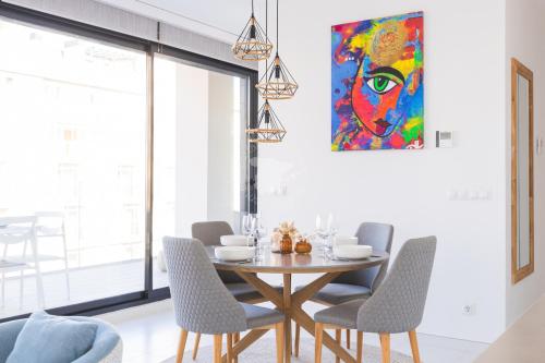 a dining room with a table and chairs and a painting at CostaBlancaDreams Calpe Beach 2 6O in Calpe in Calpe