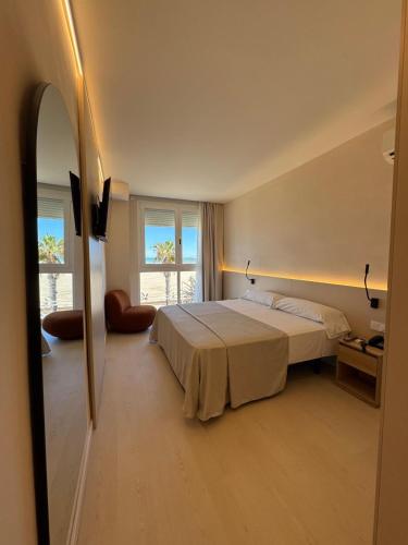a bedroom with a bed and a large window at El Globo in Valencia
