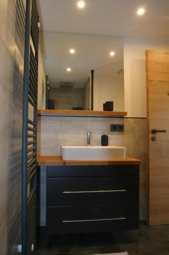 a bathroom with a sink and a mirror at Rinken9 in Hinterzarten