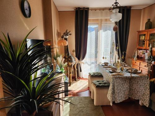 a living room with a table and a plant at Sophia Apartment Triora in Triora
