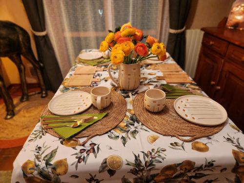 a table with a vase of flowers on it at Sophia Apartment Triora in Triora