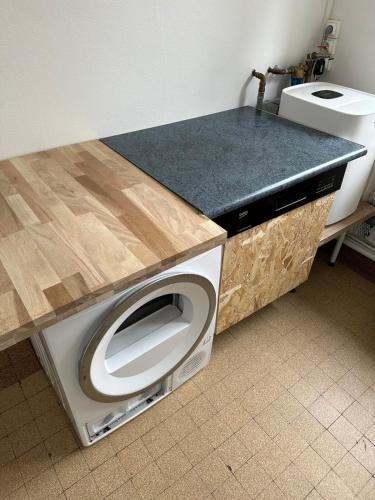 - un lave-linge dans la cuisine avec un comptoir dans l'établissement Appartement place Nevers, à Charleville-Mézières