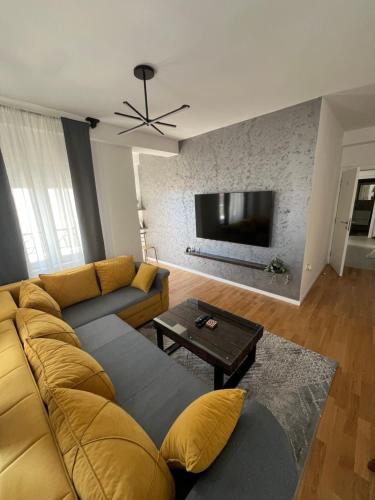 a living room with a couch and a flat screen tv at LiboroApartments in Niš