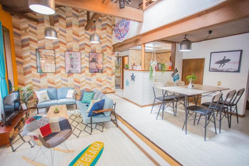 a living room with a table and chairs at Hill Atagawa Villent in Higashiizu