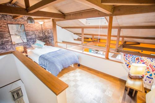 a attic room with a bed and a staircase at Hill Atagawa Villent in Higashiizu