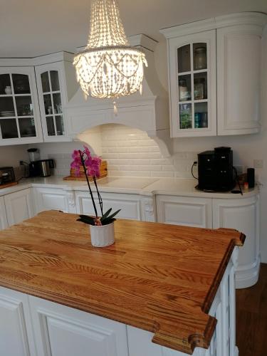 a kitchen with a wooden table with flowers on it at VILLA Turmmattli in Sarnen