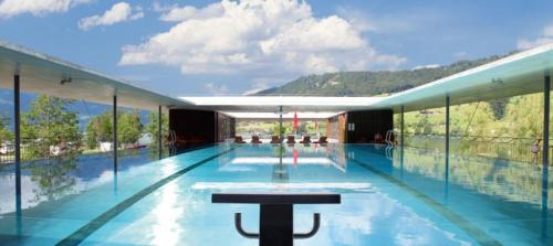 a large swimming pool with a view of a mountain at VILLA Turmmattli in Sarnen