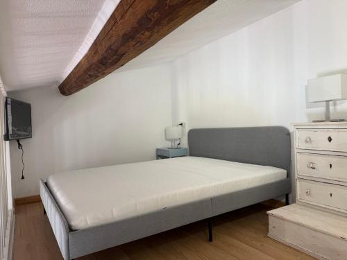 a bedroom with a bed and a dresser at Blu Celeste in Porto Santo Stefano