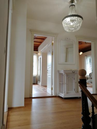 a hallway of a home with a chandelier at VILLA Turmmattli in Sarnen