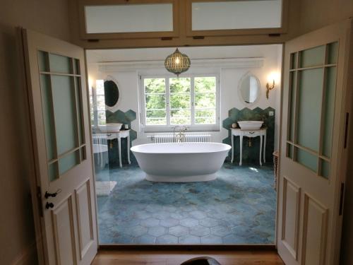 a large bathroom with a tub and a window at VILLA Turmmattli in Sarnen