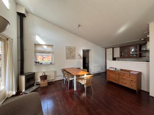 a living room with a wooden table and a couch at Vakantiehuis Petrarca in Putten