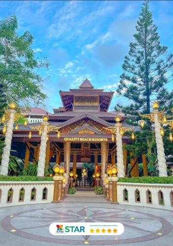 a building with a gate in front of it at Quality Beach Resorts and Spa Patong in Patong Beach