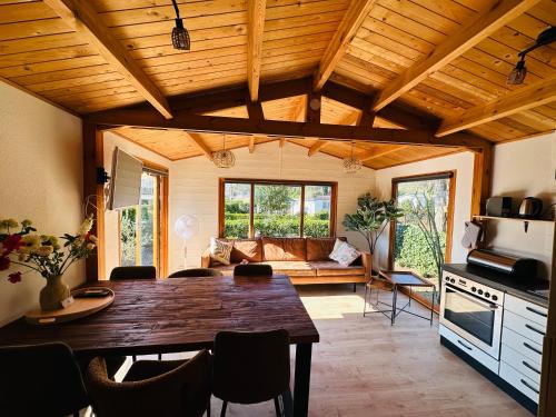 a living room with a table and a couch at Ons Schatje op 5-sterren vakantiepark De Schatberg in Sevenum