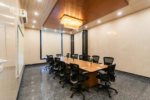 a conference room with a long table and chairs at Foxoso Fiori Hotel in Jaipur