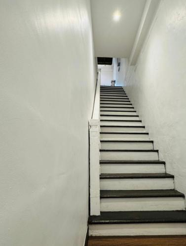 a stairway with white walls and white stairs at 1917 By MUO in Muar