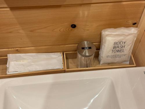 a bathroom with a sink and a bag of towels at P's Wood 箱根仙石原 in Hakone