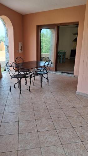 a patio with a table and chairs on a tile floor at Marana apartments with private beach in Santa Marinella