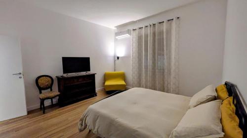a bedroom with a bed and a yellow chair at Terry's house in Ciampino