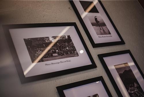 a group of framed pictures on a wall at Plataran Puncak Suites in Puncak