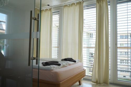a bedroom with a bed in front of a window at Gardar in Bolzano