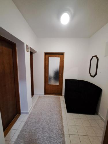 a hallway with a door and a mirror on the wall at Most in Stolac