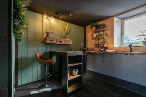 une cuisine avec un comptoir, une table et une fenêtre dans l'établissement La cachette du Couvent, balnéo, patio, à Pontivy