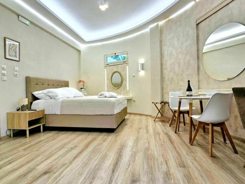 a bedroom with a bed and a table and a mirror at Golden City Center Suites in Rhodes Town
