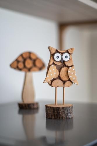a wooden figurine of an owl sitting on a table at casa stefano in Piumarola