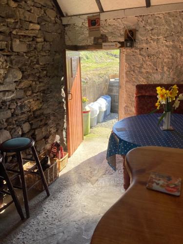 a room with a table and a door in a building at Glór na d'Tonnta Glamping Campervan in Easkey