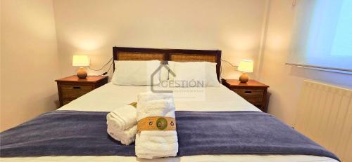 a bedroom with a bed with two towels on it at La Gran Manzana de Villaviciosa in Villaviciosa