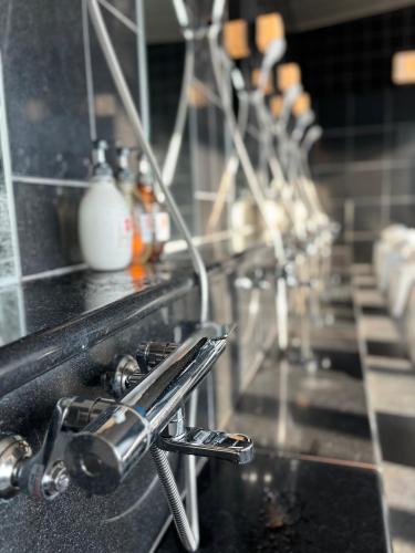 a kitchen counter with a sink with aaucet at Chateraise Hotel Nagano in Nagano