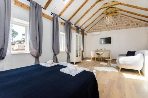a bedroom with a blue bed and a living room at Dubrovnik Finest Apartments in Dubrovnik
