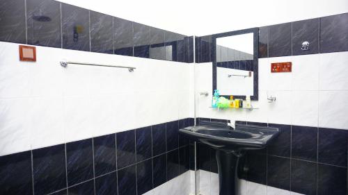 a bathroom with a sink and a mirror at Dambulla Village Hotel & Restaurant in Dambulla