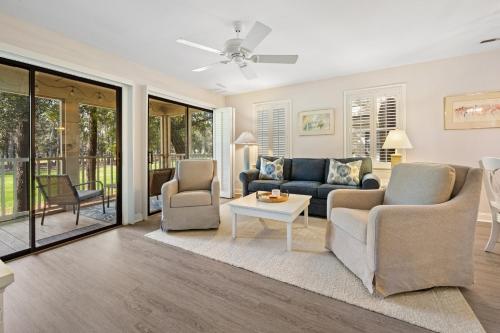 a living room with two couches and a table at Fairways & Ocean Breeze condo in Pawleys Island