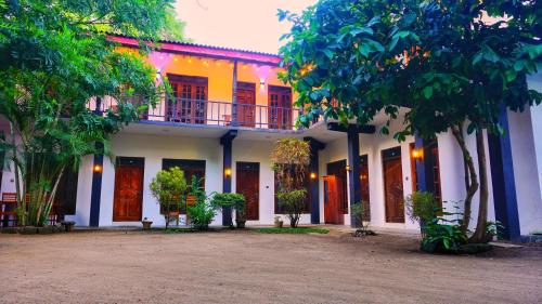 a building with a balcony on top of it at Dambulla Village Hotel & Restaurant in Dambulla